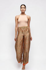 ALBANA New York apricot silk wide leg pants with a vibrant paisley print and elastic waist worn by a model.