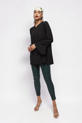 ALBANA New York black textured crepe tunic with wide sleeves and high neck worn by a model in dark green leggings.