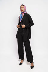 Model wearing ALBANA New York black crepe wide leg pants and matching button-down shirt with a colorful headscarf.