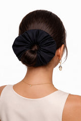 ALBANA New York black ponte fabric scrunchie worn on a woman's bun for a voluminous and sophisticated hairstyle