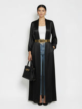 ALBANA New York black satin longline duster abaya with side pockets worn over jeans and a white top