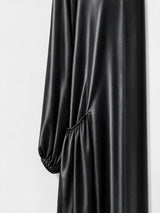 ALBANA New York black satin duster abaya featuring gathered side pockets and long sleeves in a smooth finish.