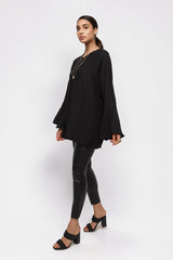 ALBANA New York black textured crepe tunic with wide sleeves and high neck worn by a model with black trousers