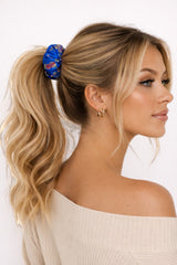 ALBANA New York blue floral brocade oversized scrunchie worn in a blonde ponytail by a woman