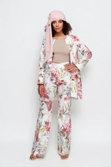 ALBANA New York floral flare pants in blush tones paired with a matching jacket and a soft pink head wrap.