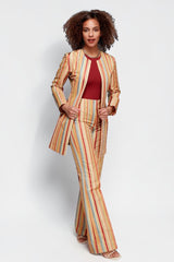 Model wearing ALBANA New York Carousel Stripe mid-rise flare pants and matching jacket in multi-colored vertical stripes