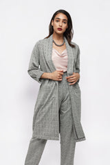 ALBANA New York model wearing grey glen plaid relaxed fit pants and matching longline blazer with a pink camisole.
