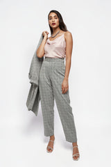 Model wearing ALBANA New York high-rise grey glen plaid relaxed fit trousers with a blush silk camisole