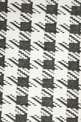 ALBANA New York oversized knit scrunchie featuring a classic black and white houndstooth pattern.