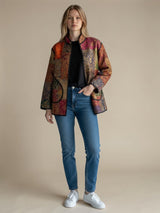 Model wearing ALBANA New York Imperial Mosaic Silk Jacket with noir trim, patch pockets, and colorful patterned silk.