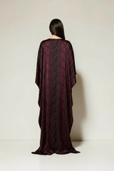 ALBANA New York Imperial Wine silk kaftan with a flowing silhouette, boat neckline, and tonal patterned maroon fabric.