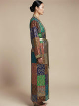 Model wearing ALBANA New York Imperial Mosaic silk kimono robe with jewel-toned patchwork and gold trim.