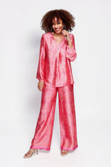 Model wearing ALBANA New York rose pink silk tunic and matching wide-leg trousers with vibrant ethnic paisley print.