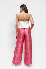 ALBANA New York rose pink silk wide leg pants with paisley print and elastic waist worn by a model from behind