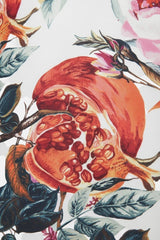 ALBANA New York cotton fabric with a vibrant hand-painted pomegranate and floral botanical print in red and green.