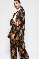 ALBANA New York black crepe button down shirt with orange and beige foliage print worn over a white turtleneck