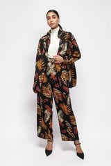Model wearing ALBANA New York printed foliage wide leg pants and matching blazer with a white turtleneck