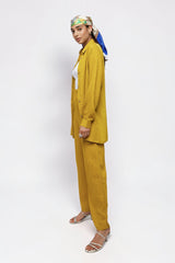 ALBANA New York saffron textured linen button-down shirt and matching wide-leg pants worn by a model in profile.