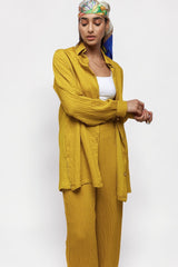 ALBANA New York saffron yellow textured linen wide leg pants and matching button-down shirt worn by a model.