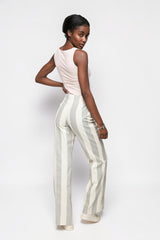 Model wearing ALBANA New York cotton flare pants with vertical stripes and double pleats, back view.