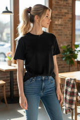 ALBANA New York mini tartan plaid scrunchie worn in a blonde ponytail by a woman in a black t-shirt and jeans