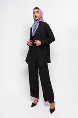 ALBANA New York black textured crepe button-down shirt worn by a model with a colorful headscarf and matching pants.