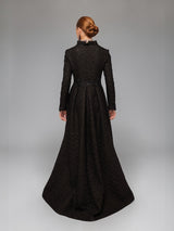 Back view of ALBANA New York floor-length black matelassé opera coat with structured bodice and box-pleated skirt.