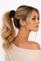 ALBANA New York black ponte fabric scrunchie worn in a blonde model's high ponytail for a chic, voluminous look.