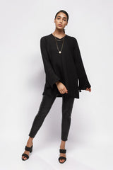 ALBANA New York black textured crepe tunic with high neck and wide sleeves worn by a model with black trousers