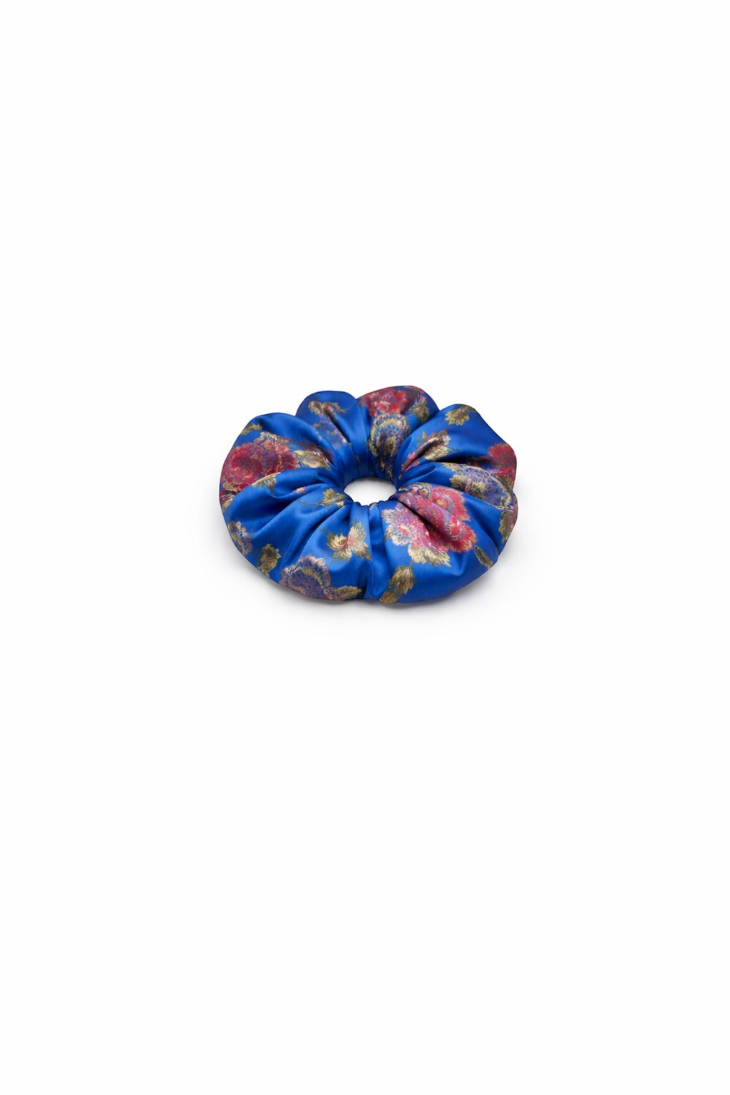 ALBANA New York oversized blue floral brocade scrunchie with a glossy finish and intricate red and gold flower pattern.