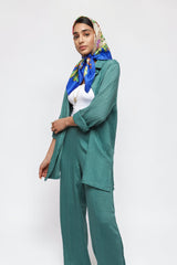 ALBANA New York blue textured linen button-down shirt worn open over a white top with matching wide-leg pants