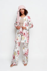 ALBANA New York floral flare pants in blush tones paired with a matching jacket and headscarf on a model.