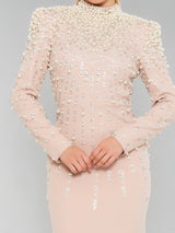 ALBANA New York blush crepe mermaid gown with pearl and crystal embellishments, mock neck, and structured shoulders.