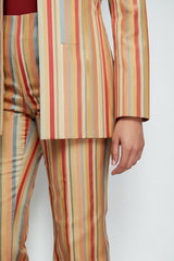 ALBANA New York Carousel Stripe flare pants in multi-colored vertical stripes made of fluid polyester fabric.