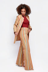 Model wearing ALBANA New York Carousel Stripe Jacket and matching flare pants in multi-coloured vertical stripes