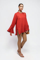 ALBANA New York coral red textured linen tunic with high neck and wide sleeves worn by a model with tan trousers