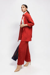 ALBANA New York coral red textured linen button-down shirt worn over a white turtleneck with matching wide-leg pants.