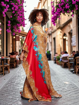 Model wearing an ALBANA New York crimson satin kaftan with gold leopard print and vibrant turquoise floral side panels.