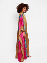 Model wearing an ALBANA New York fuchsia and gold satin kaftan with wide sleeves and mixed motif print