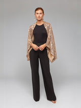 ALBANA New York gold sequin bolero sleeves worn over a black sleeveless top and trousers for an elegant evening look