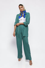 ALBANA New York La Mer blue textured linen button-down shirt worn open over a white top with matching wide-leg pants.