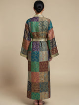 Model wearing ALBANA New York Imperial Mosaic silk kimono robe with jewel-toned patchwork and gold trim.