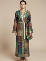 Model wearing ALBANA New York silk kimono robe with jewel-toned mosaic patchwork, gold trim, and matching belt.