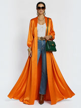 ALBANA New York orange satin maxi duster abaya worn over jeans and a white top with gold accessories