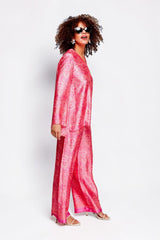 Model wearing ALBANA New York rose pink silk tunic and matching wide-leg pants with vibrant ethnic-inspired print
