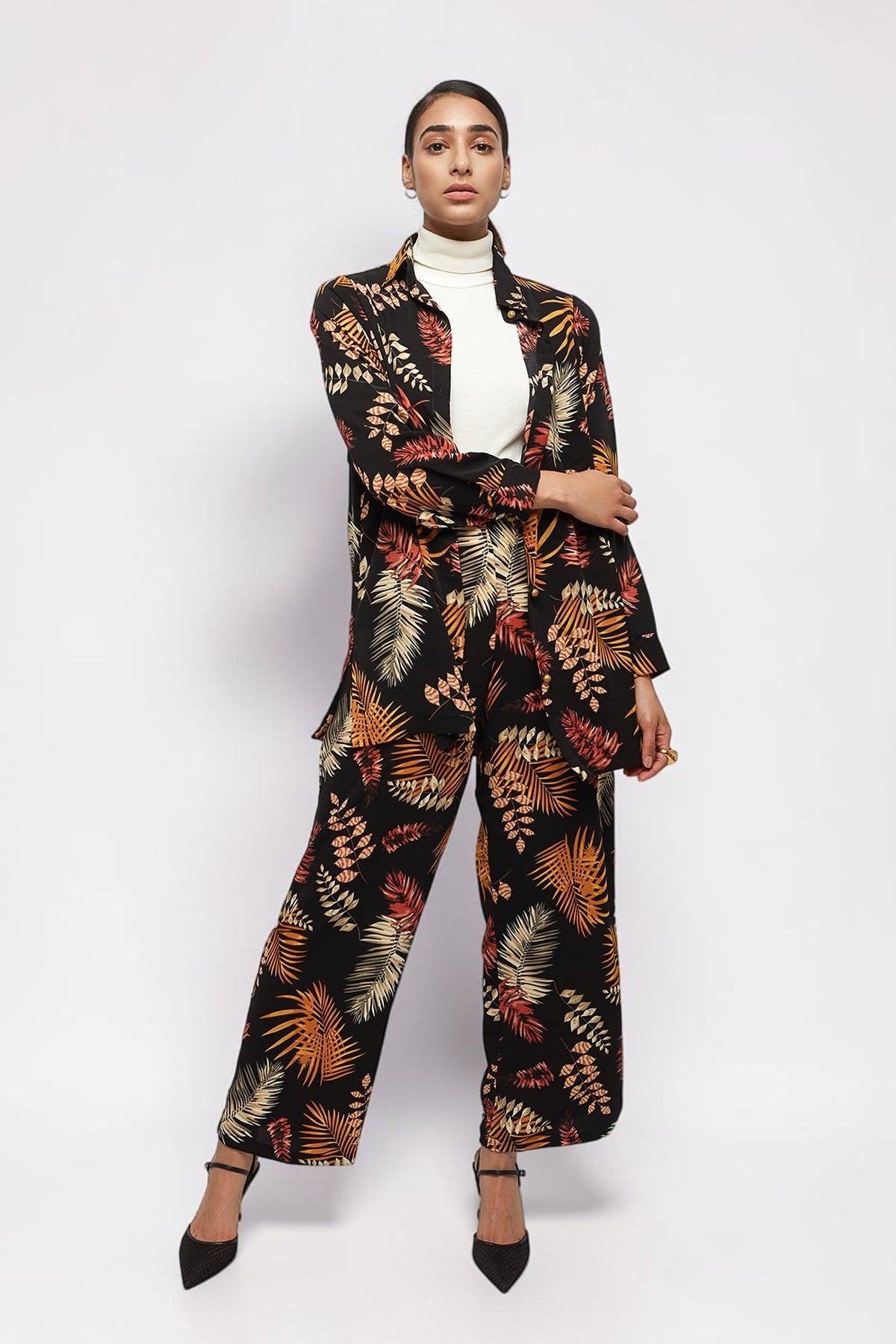 ALBANA New York model wearing matching black crepe foliage print wide leg pants and button-down shirt