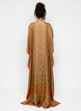 Back view of an ALBANA New York silk kaftan maxi dress with a vibrant orange and green paisley print and kimono sleeves.