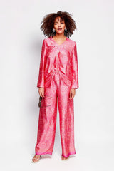ALBANA New York rose pink silk tunic and matching wide-leg pants with ethnic print worn by a model in a studio.