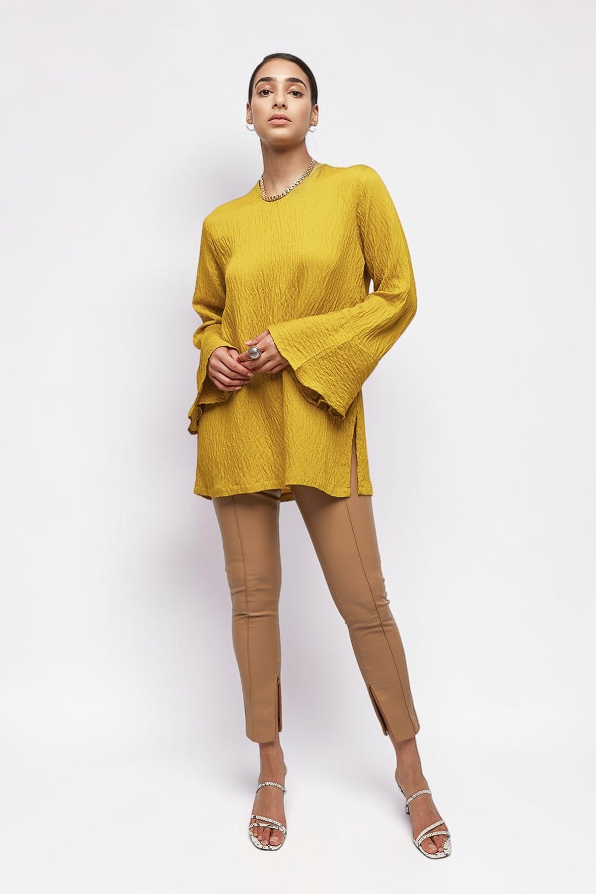 ALBANA New York saffron yellow textured linen tunic with high neck and wide sleeves worn by a model