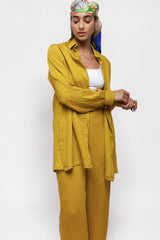ALBANA New York saffron yellow textured linen button-down shirt worn by a model with a matching headscarf